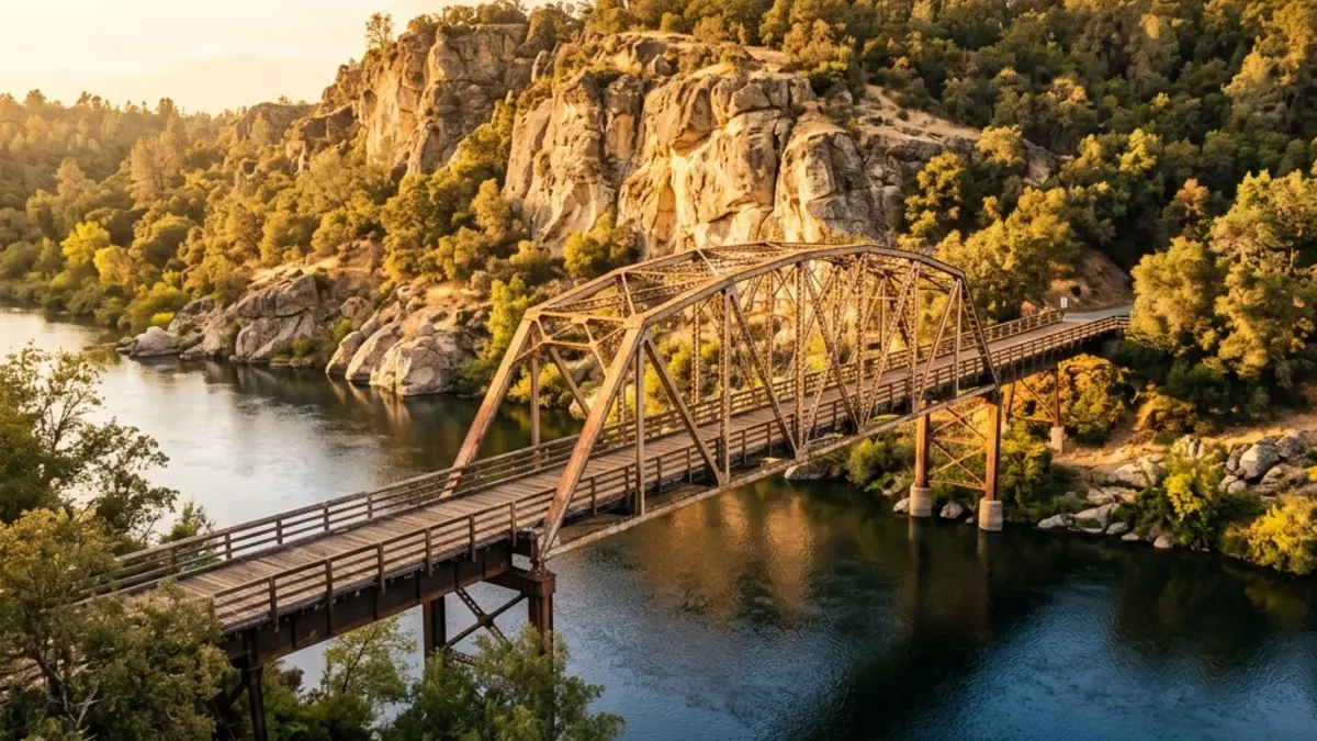 The historic truss Fair Oaks Bridge crossing the American River at golden hour.